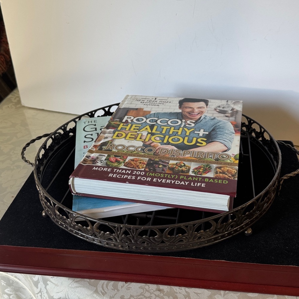 Round dule black, wrought iron stand and tray. It has a folding easel-style back